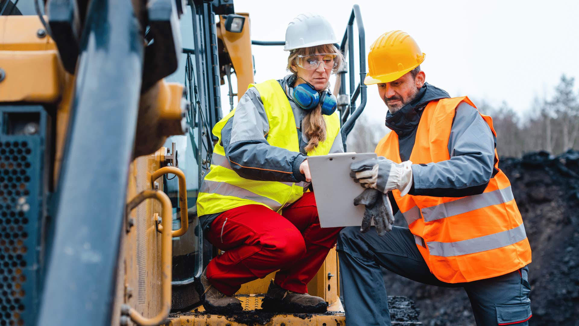 construction workers looking at notes together