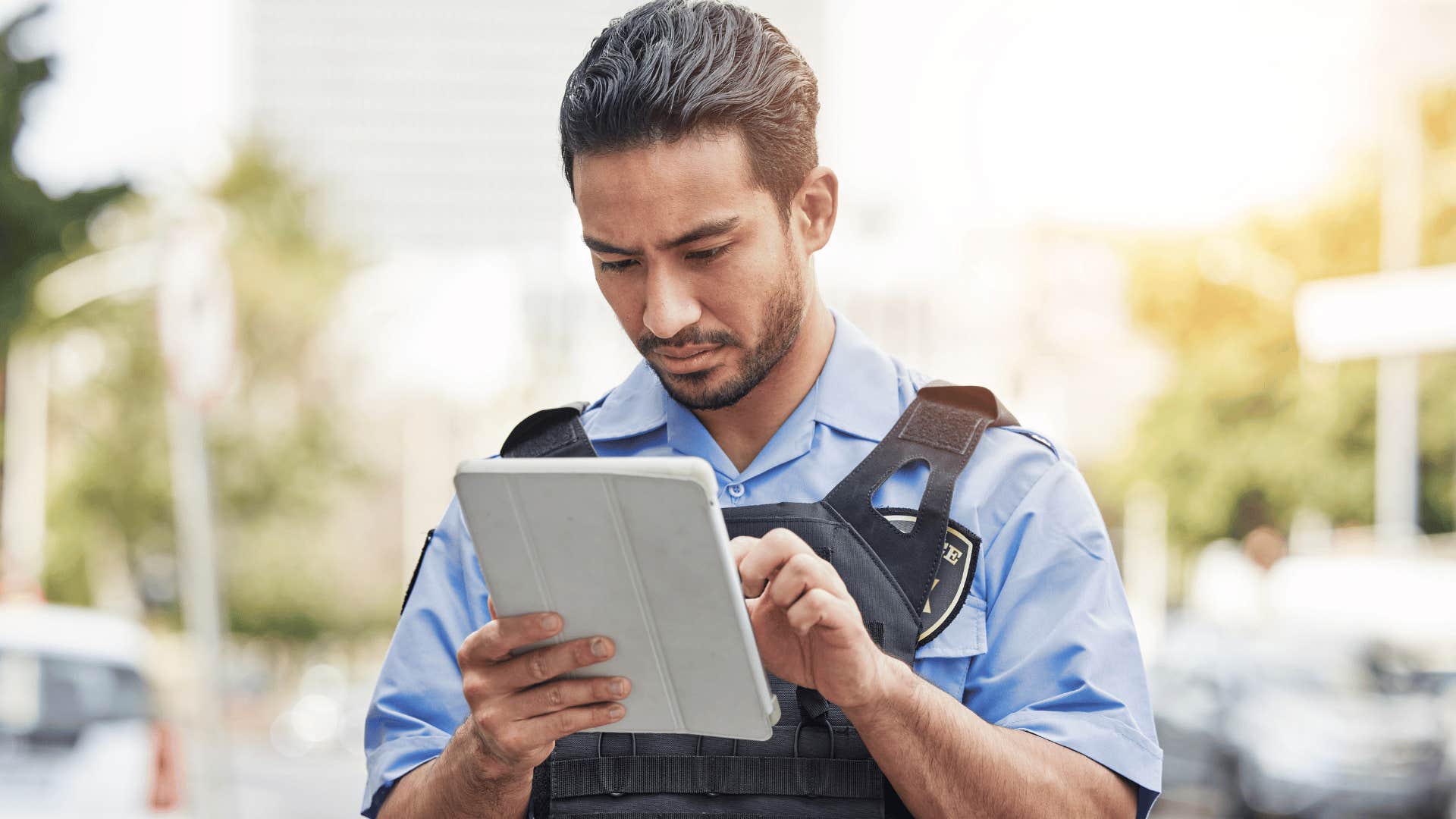 grey collar police officer looking at document