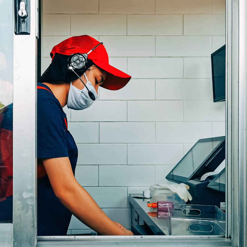 Burger King employee working at the drive thru. 