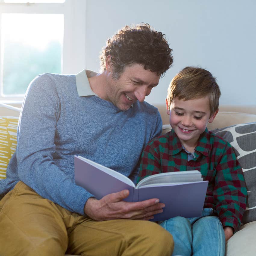 dad and happy son reading together