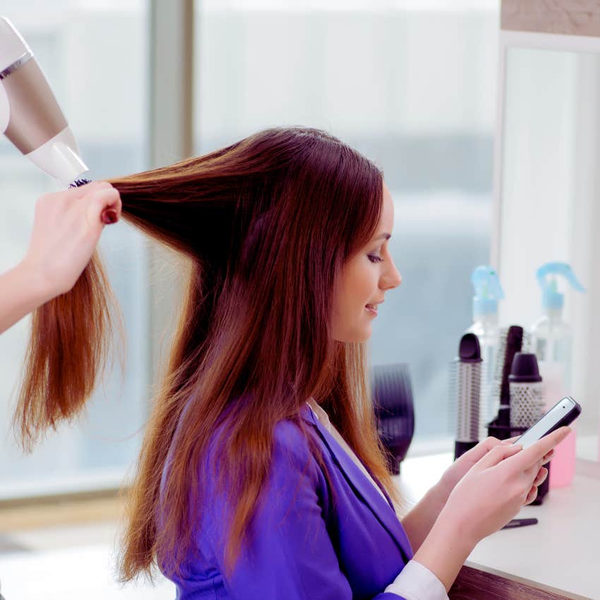 Gen Zer texting while getting her hair styled