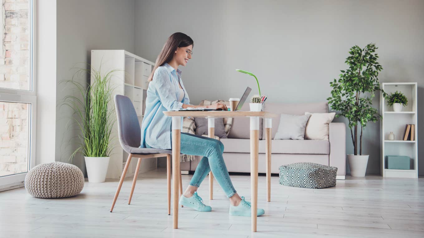 woman sitting at a desk in jeans