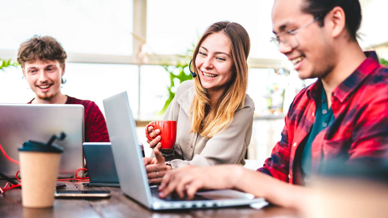 Young coworkers busy at computers in startup studio