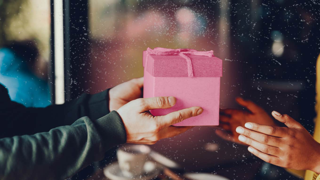 Generous person hands off gift to the person he is in a relationship with.