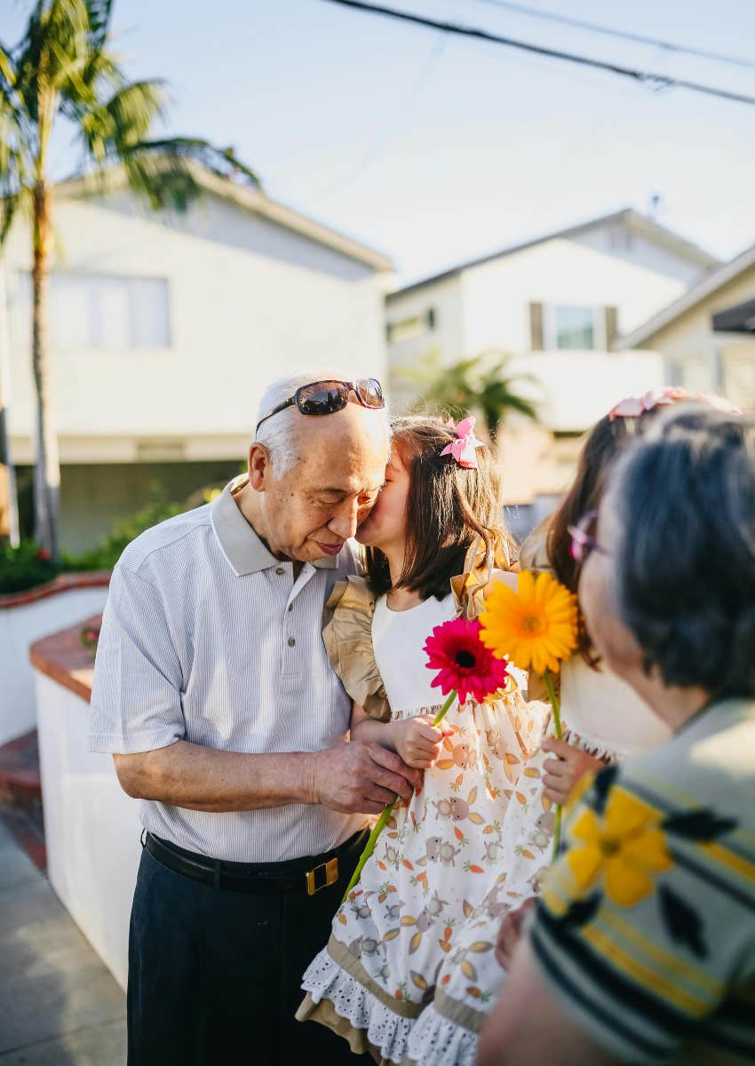 grandparents hugging two granddaughters