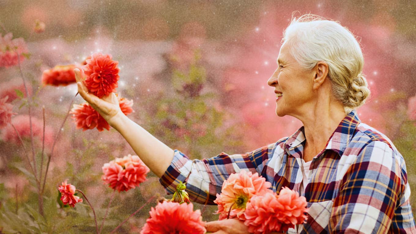 Happy woman picking flowers 