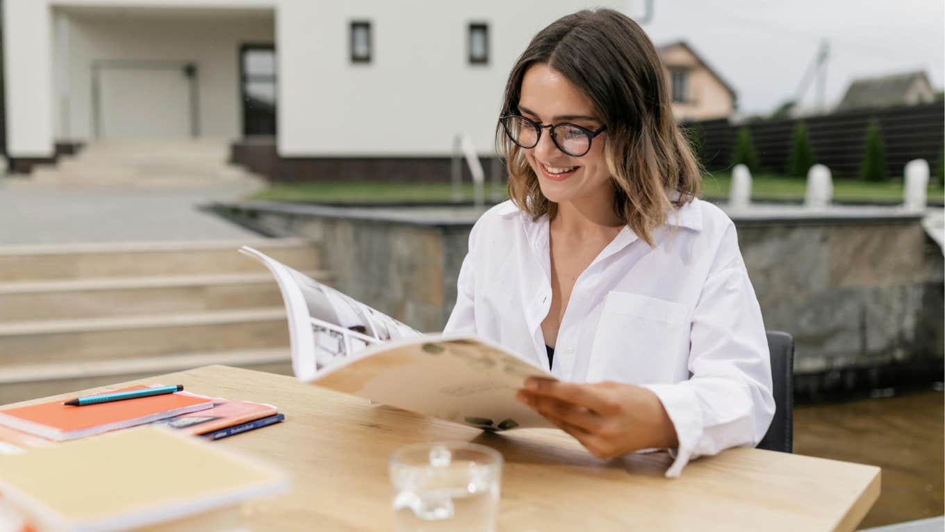 woman sitting outside reading