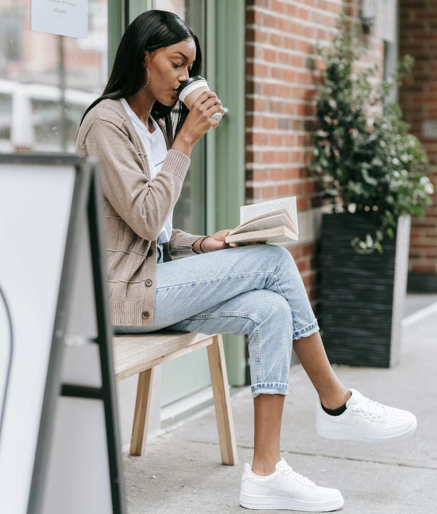 woman drinking coffee and reading