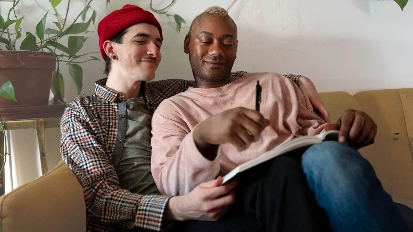 Queer situationship hugging on the couch. 