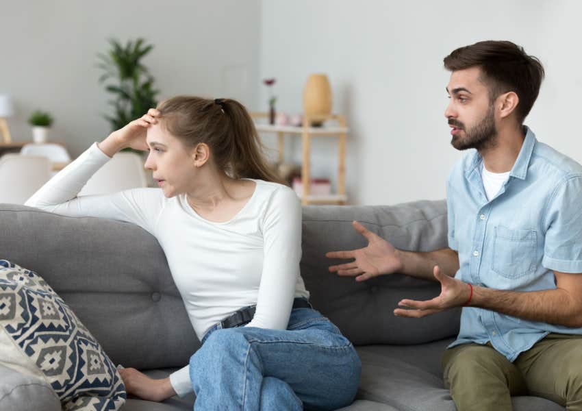 husband trying to compromise with resentful wife on couch at home