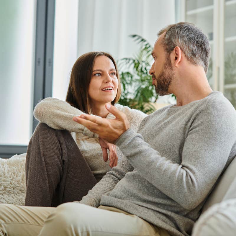 couple talking on cozy couch in modern living room