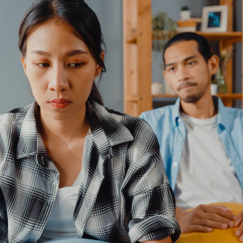 upset couple not facing each other on couch