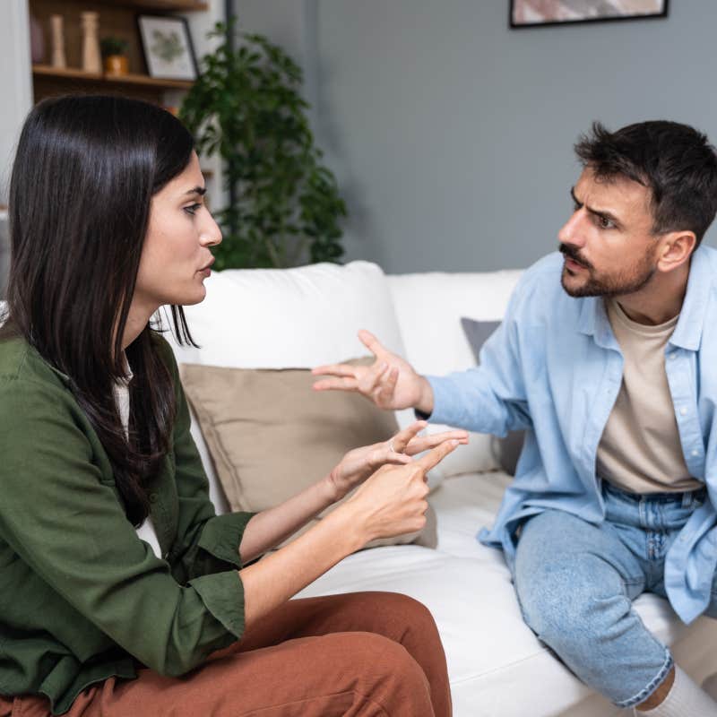 couple having argument on couch