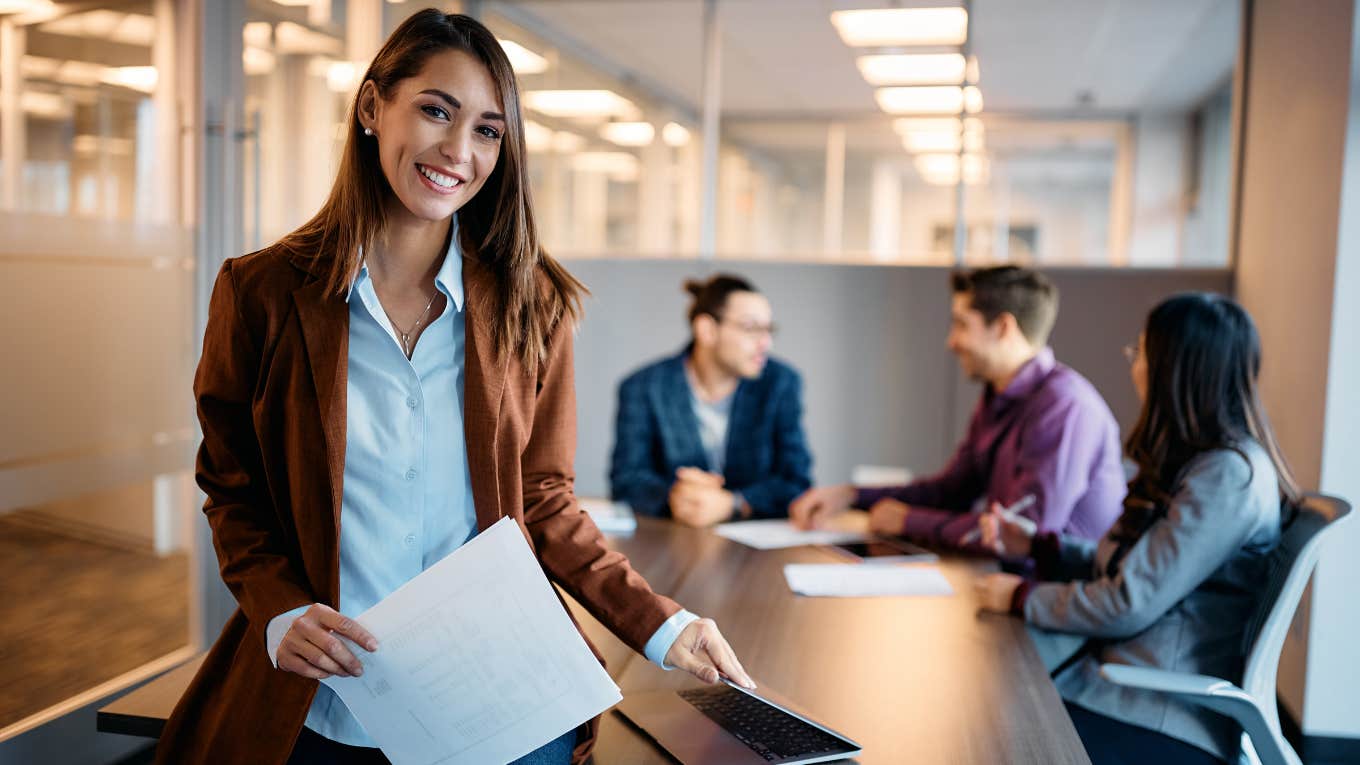 female employee in office with coworkers