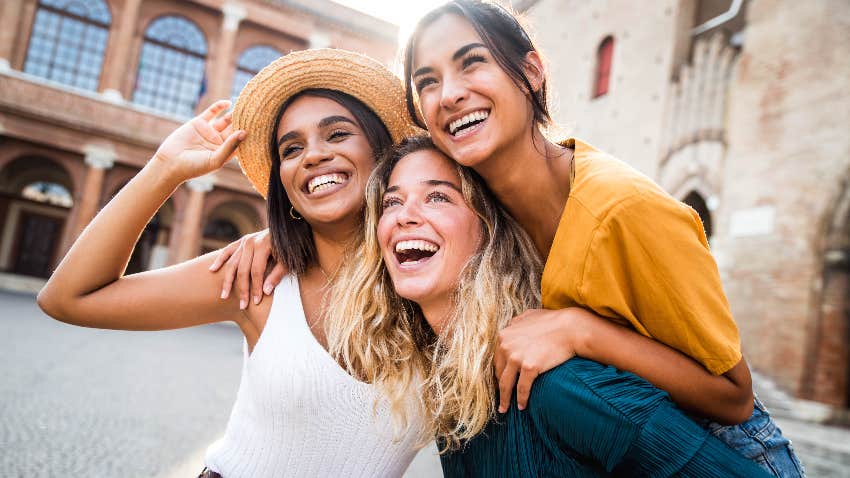 group of girls smiling and hugging each other