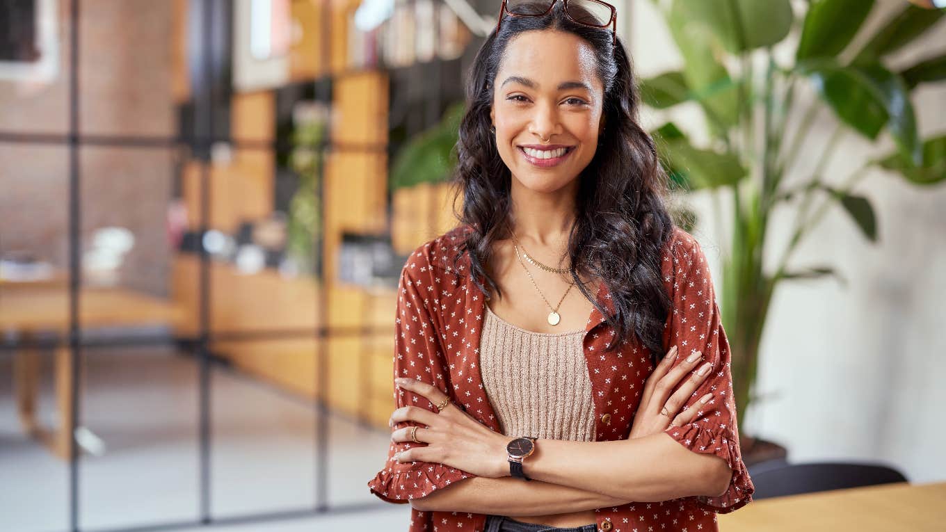 woman crossing arms while smiling