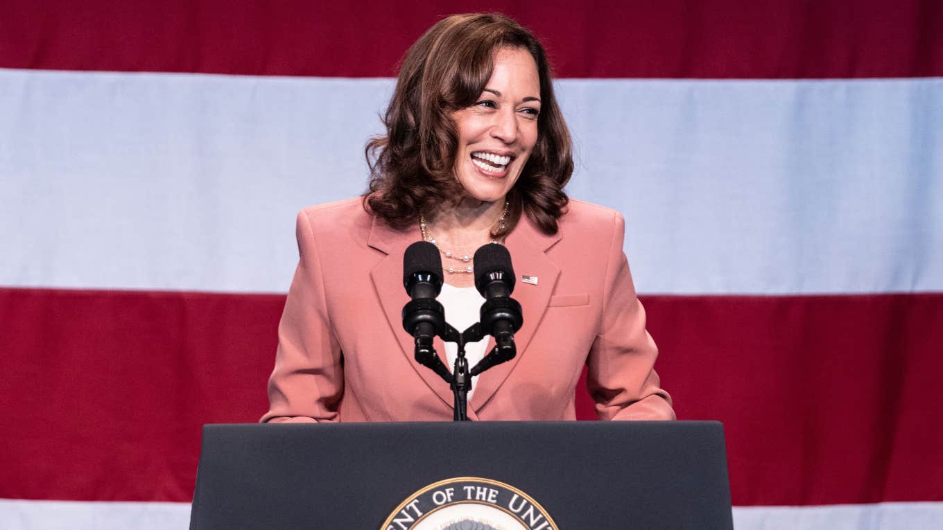 Kamala Harris standing at a lectern giving a speech