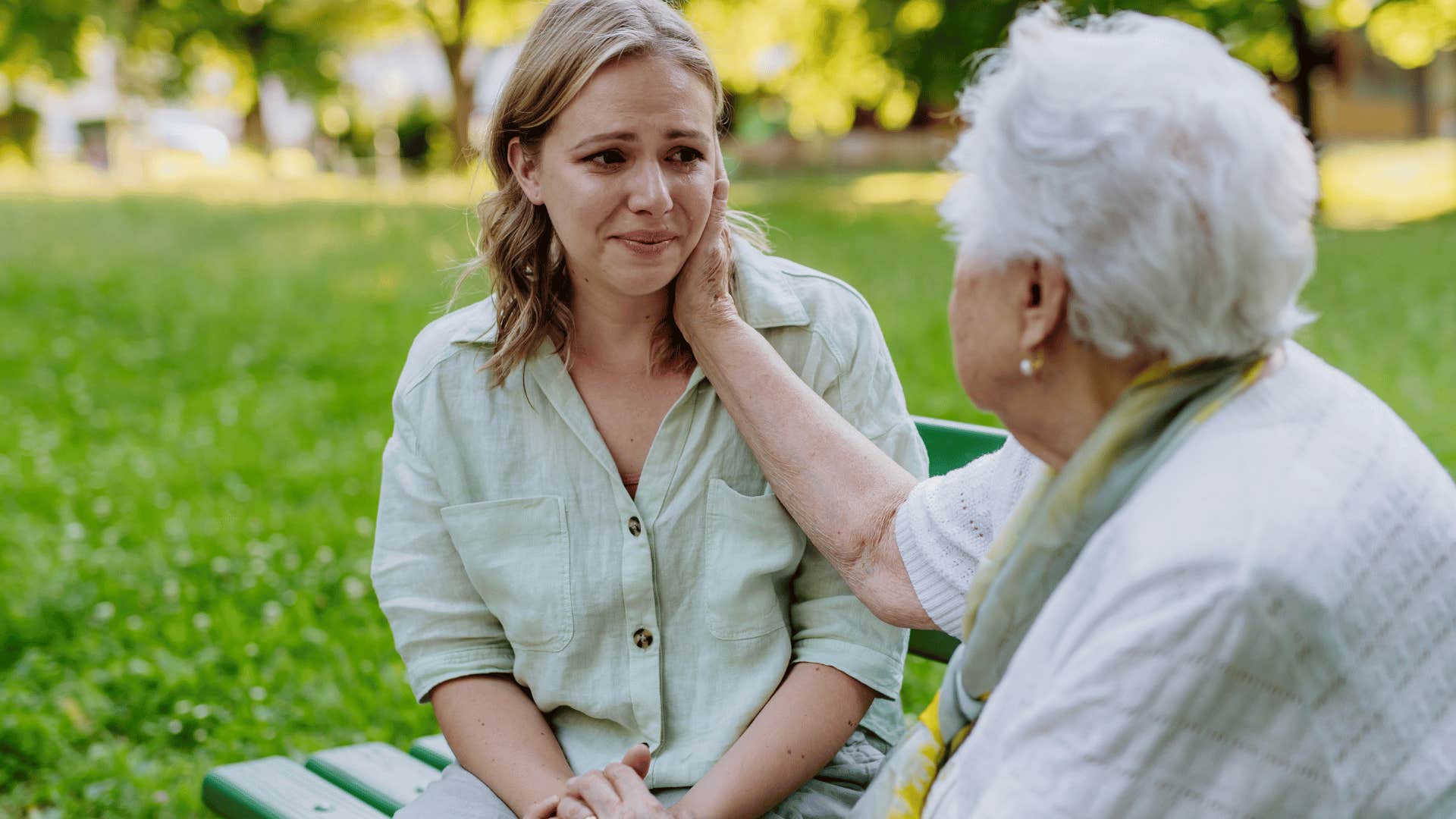 older woman comforting crying younger woman under thirty eight 