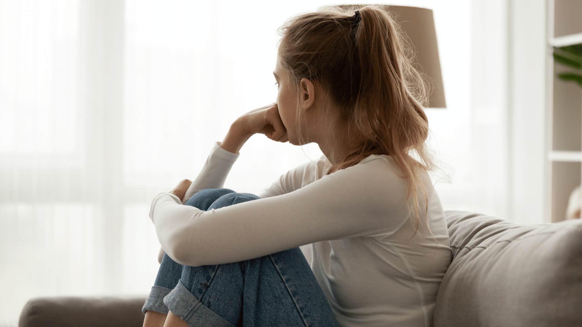 woman under thirty eight minding business and looking outside 