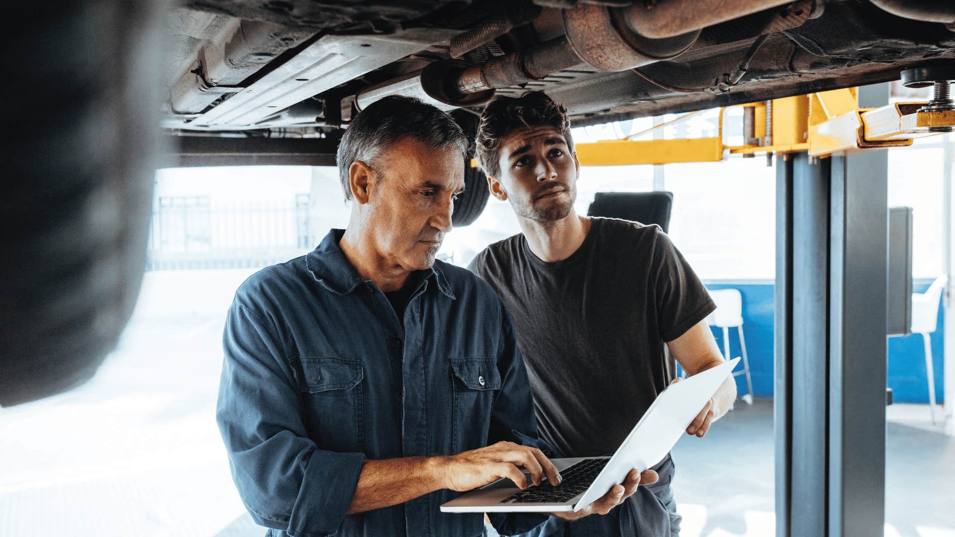 men fixing car 