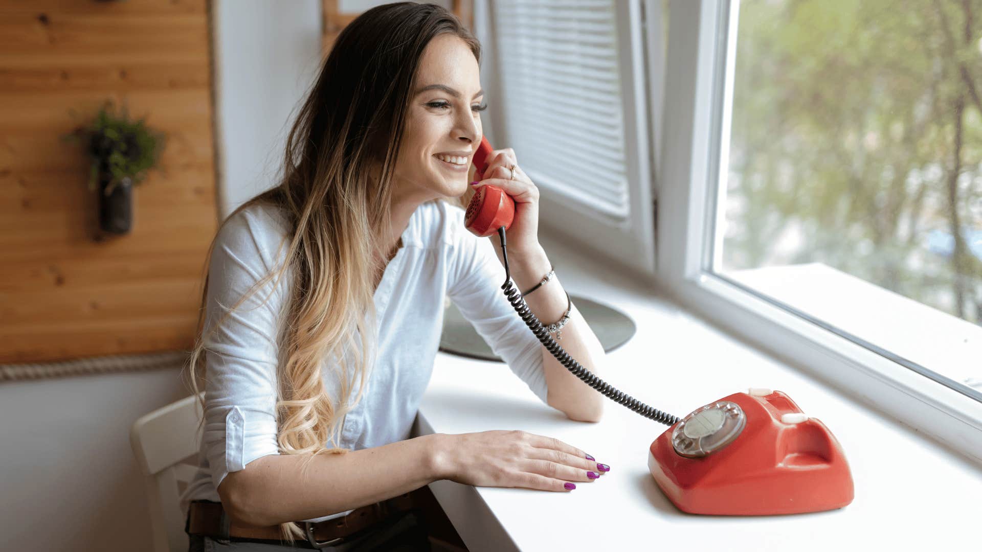 woman under thirty eight using old telephone