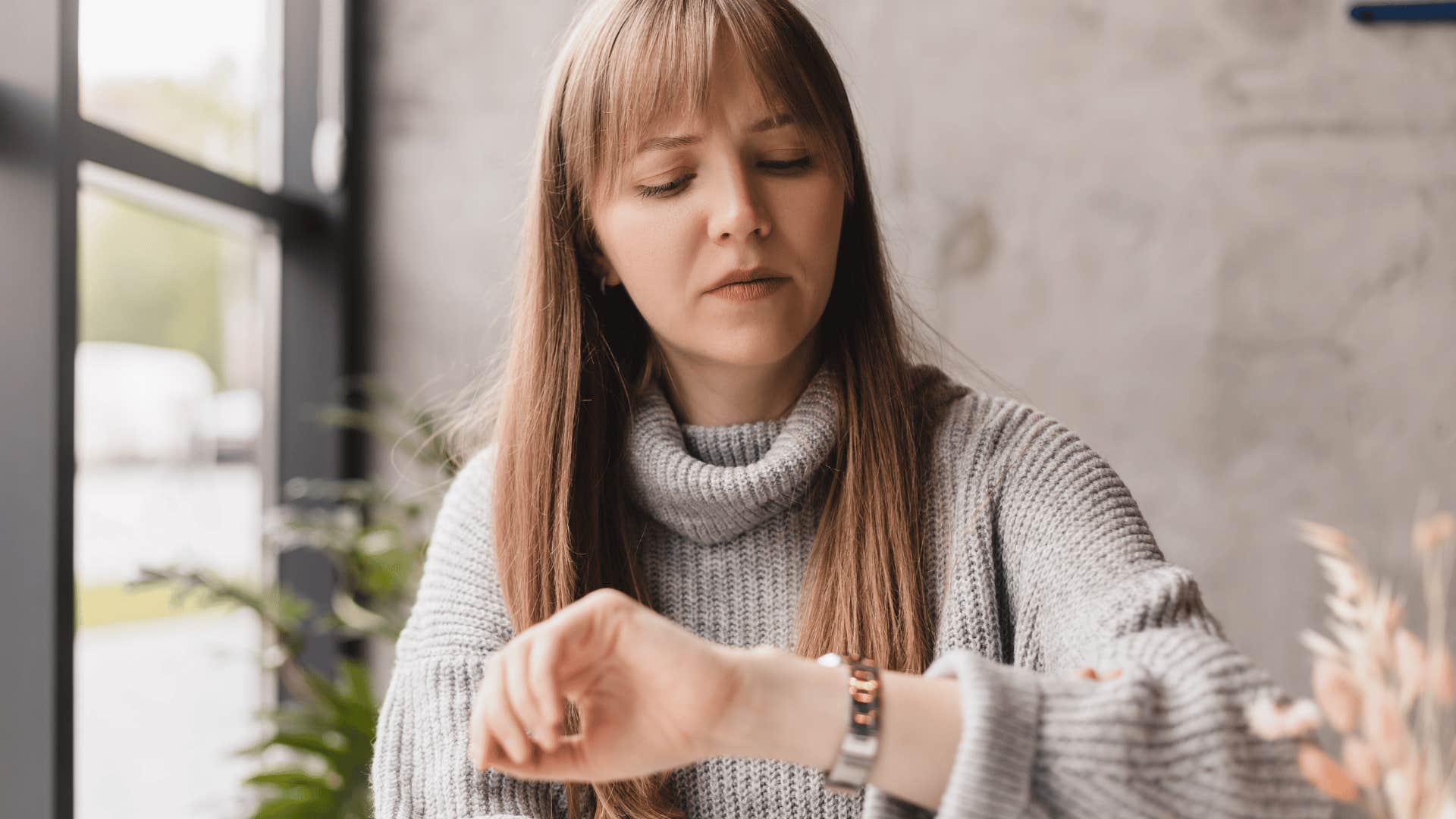 woman under thirty eight checking watch 