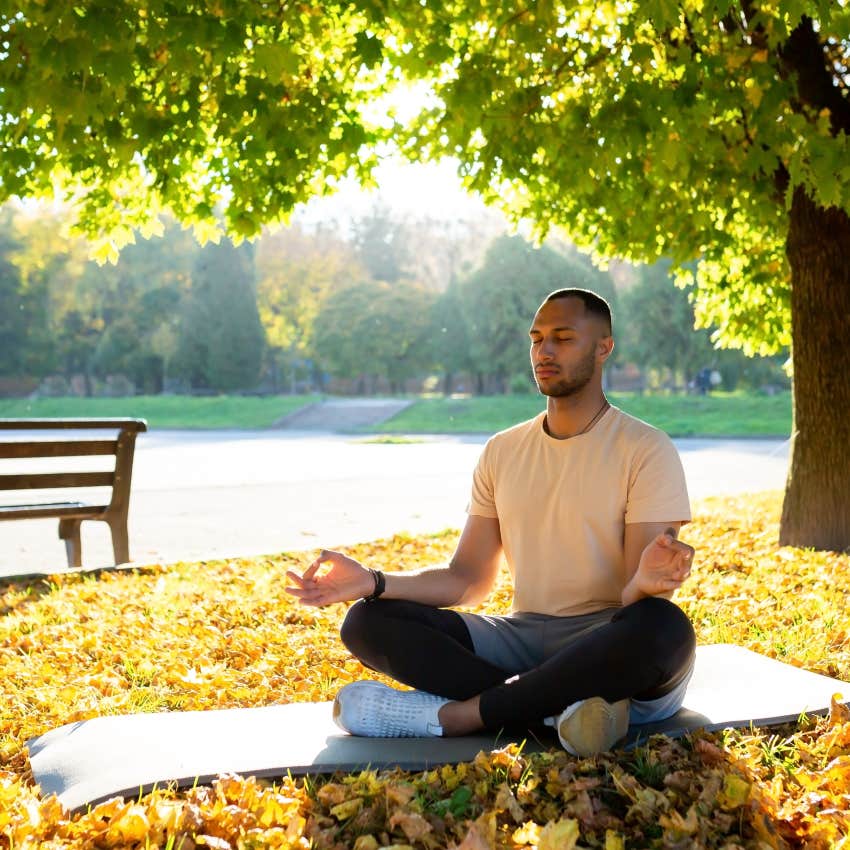 man meditating in park to harness his anger