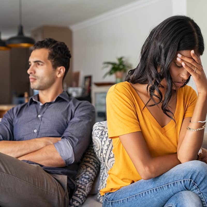 young couple sitting on couch after a fight