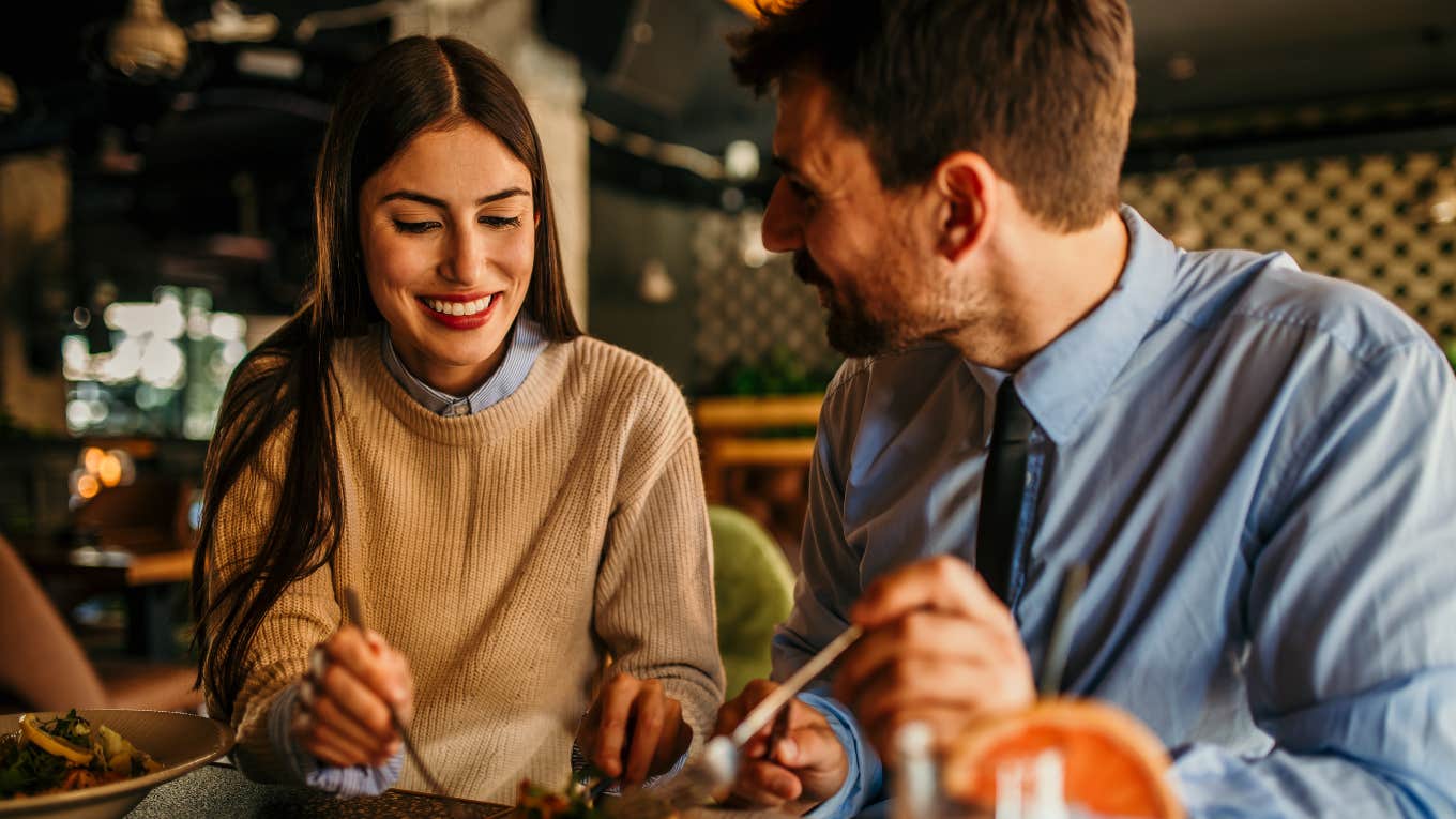 Couple splits the bill while eating at a restaurant. 