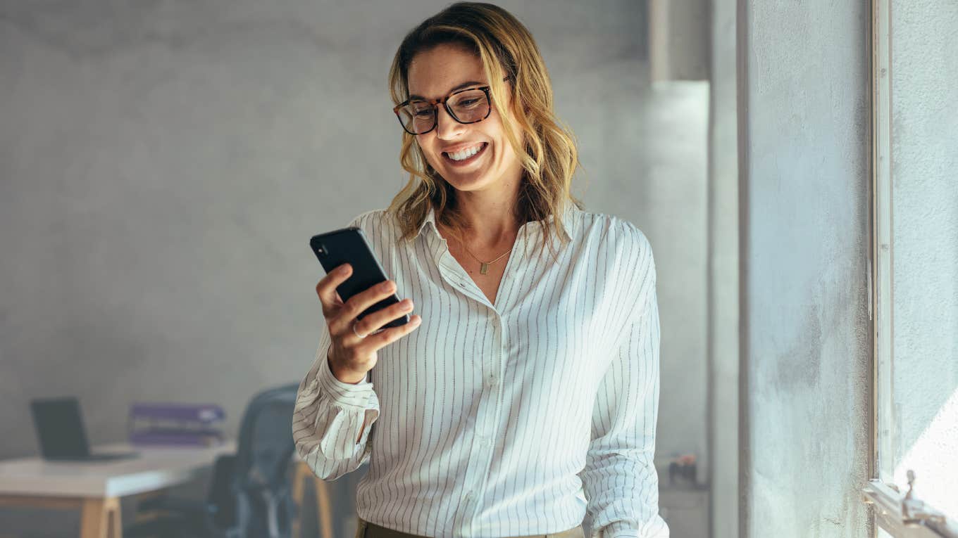 Millennial boss reading a text from employee about sick time. 