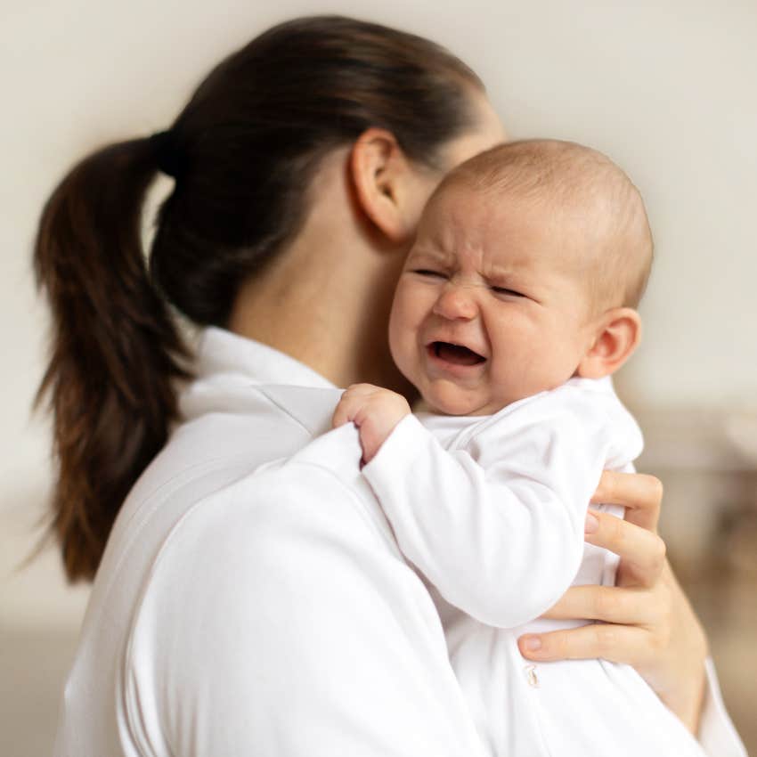 mom holding crying baby