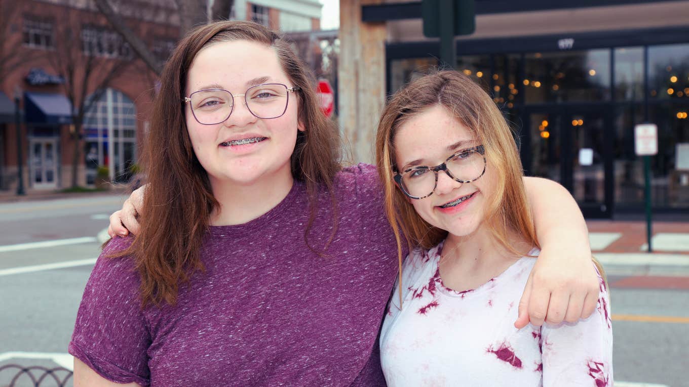 Twin teen sisters smiling for photo