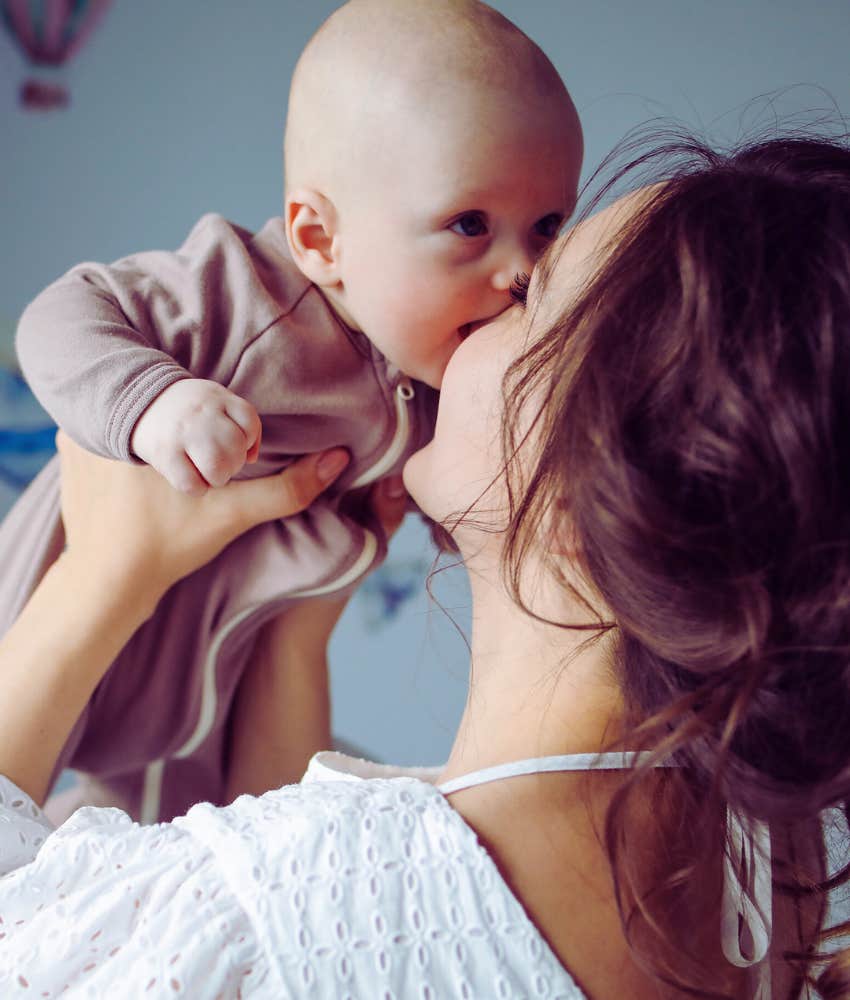 mom getting kiss on the nose from baby