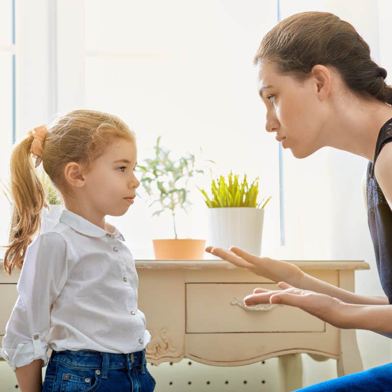 mom disciplining little girl