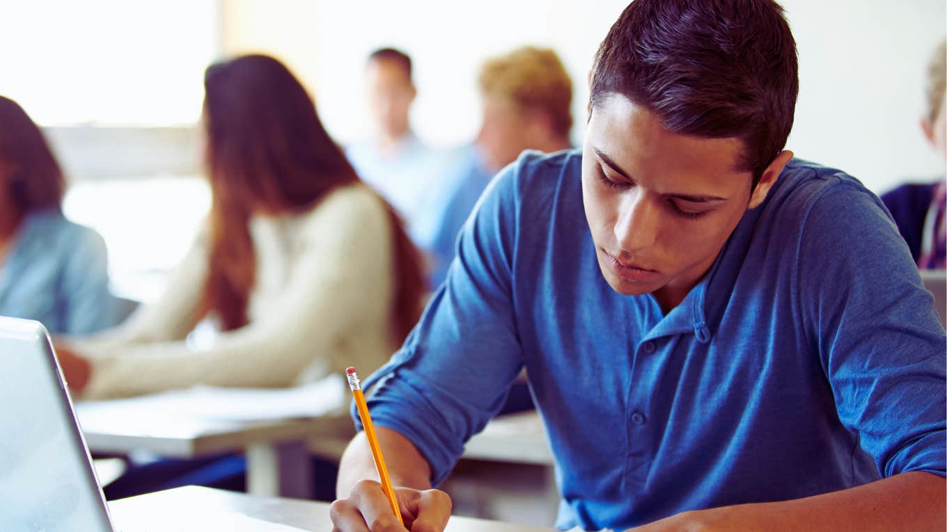 High school student completing assignment in class