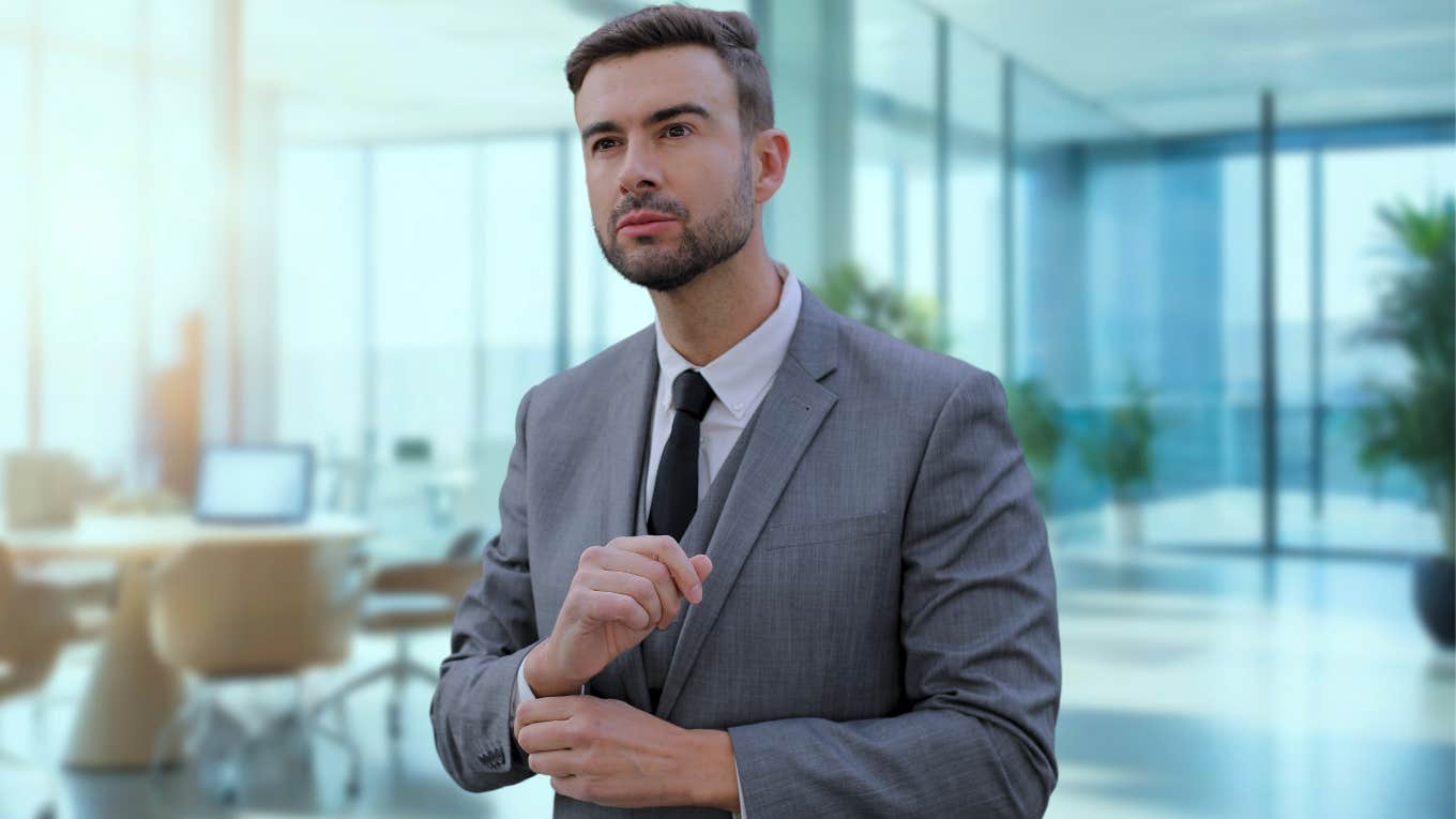 Narcissist man standing in a fancy office. 