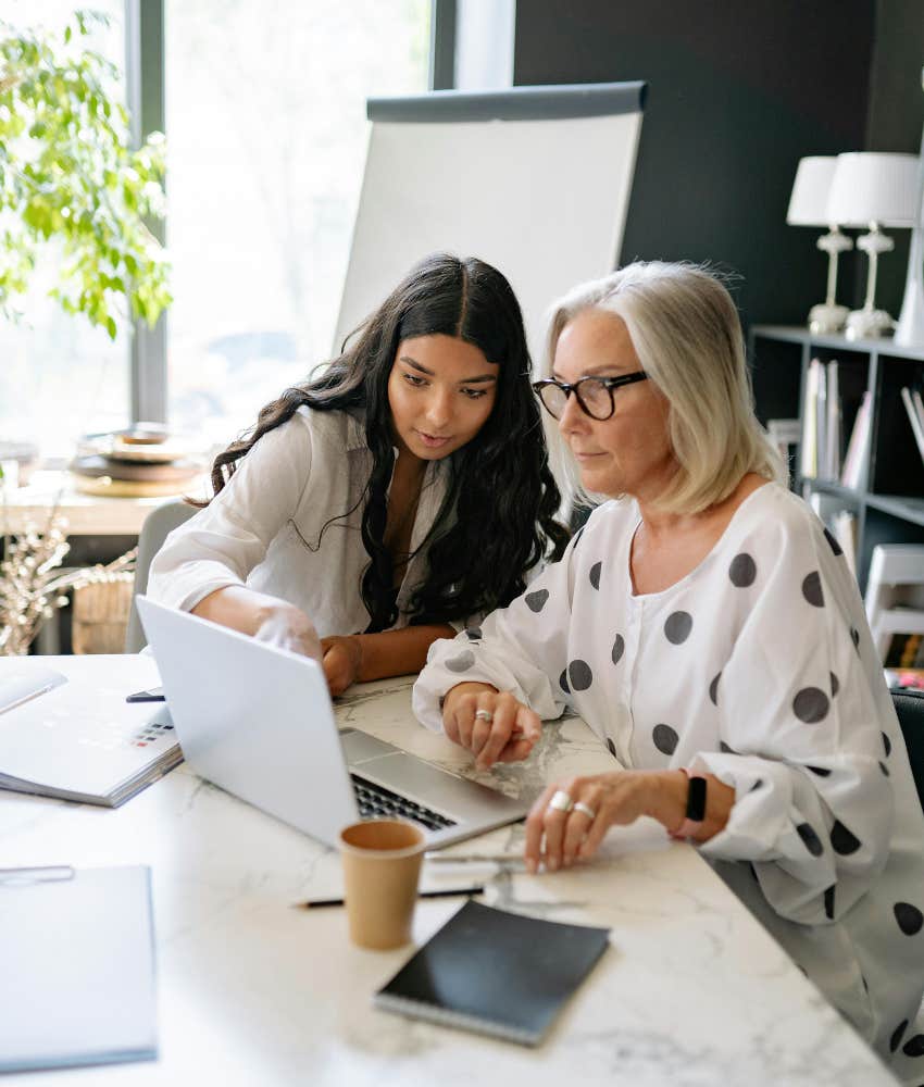 two women working on a laptop 