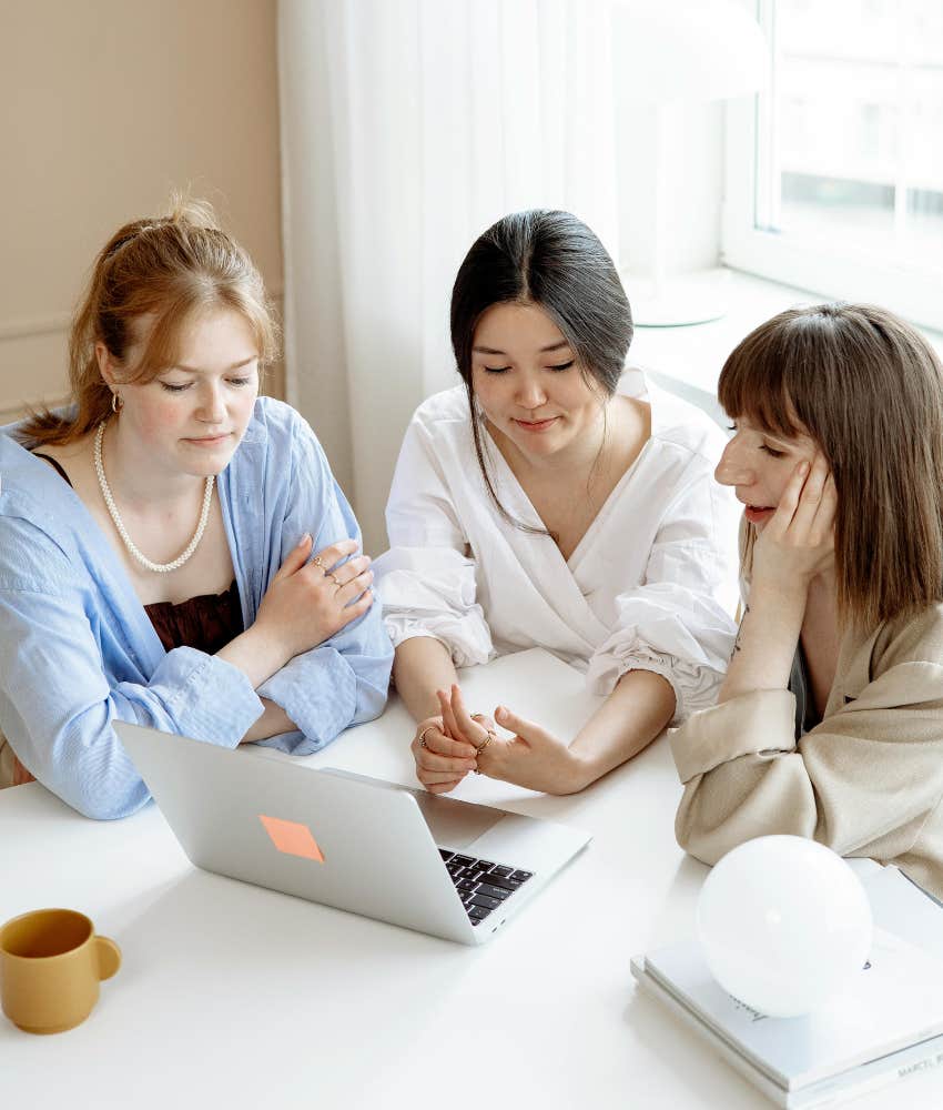 three female employees work together