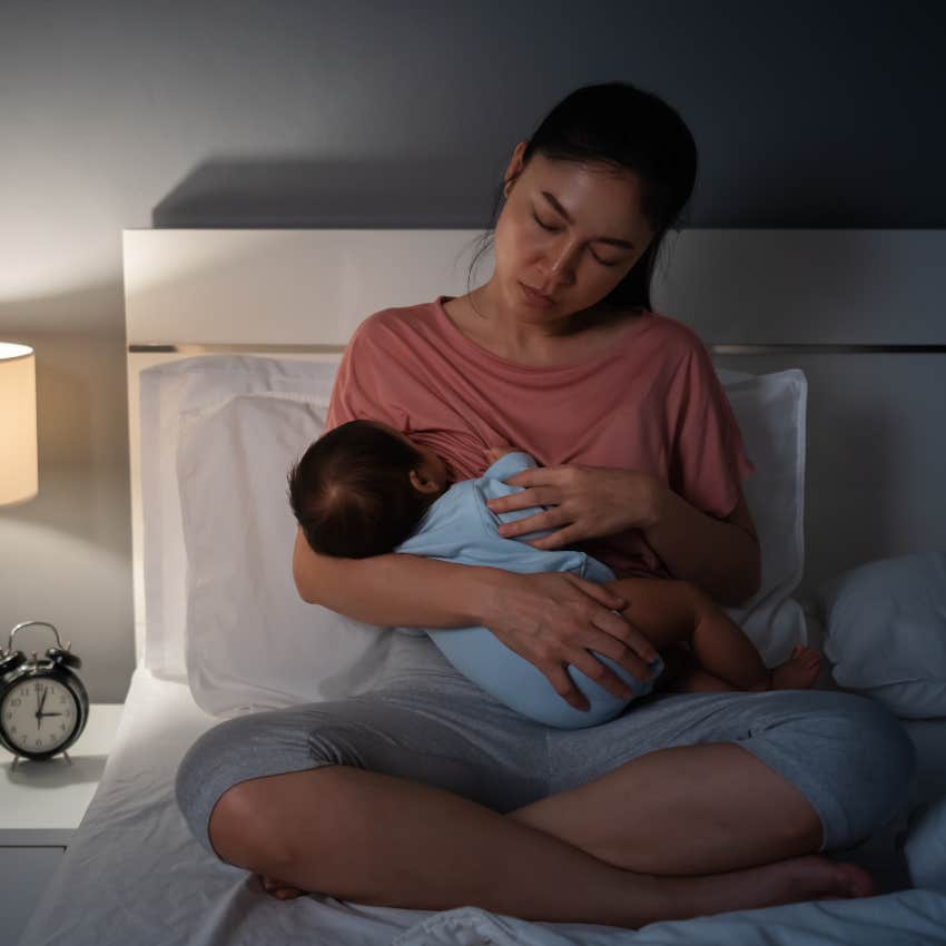 Mother on maternity leave holding her newborn at night. 