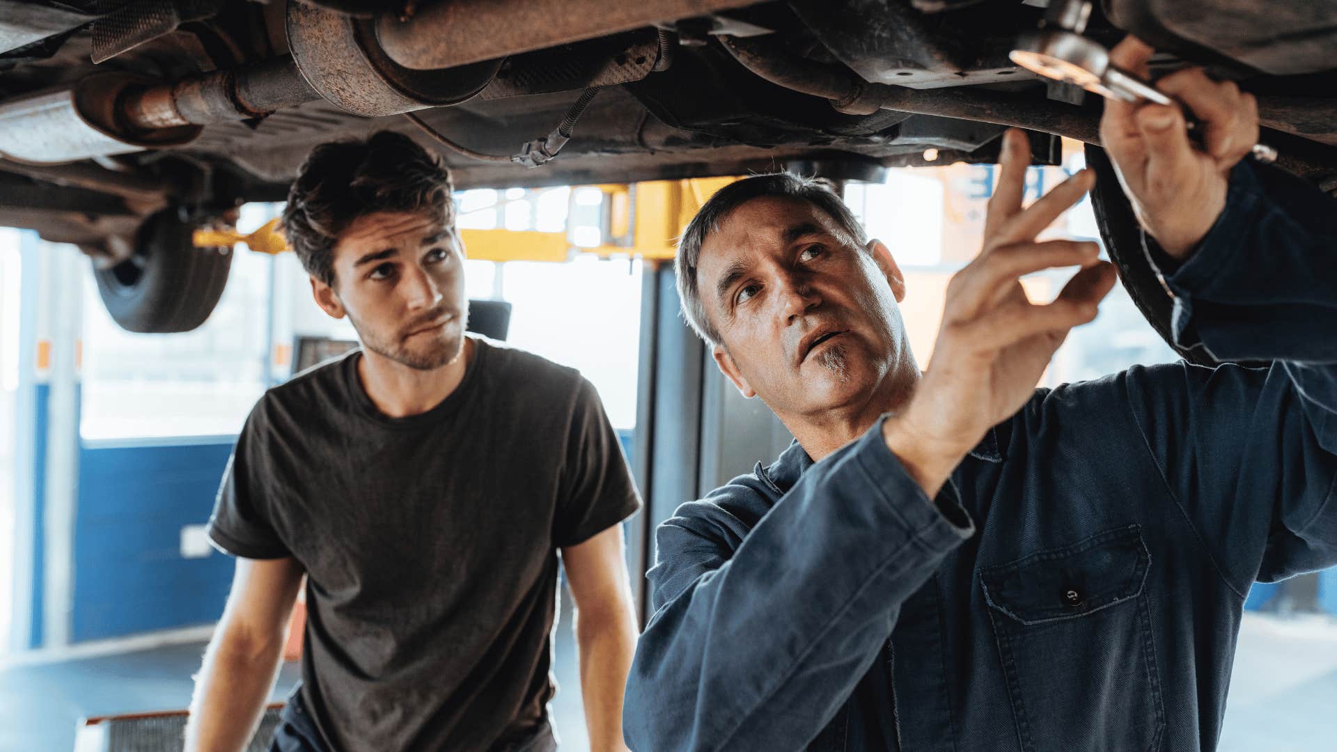 two frugal men fixing car