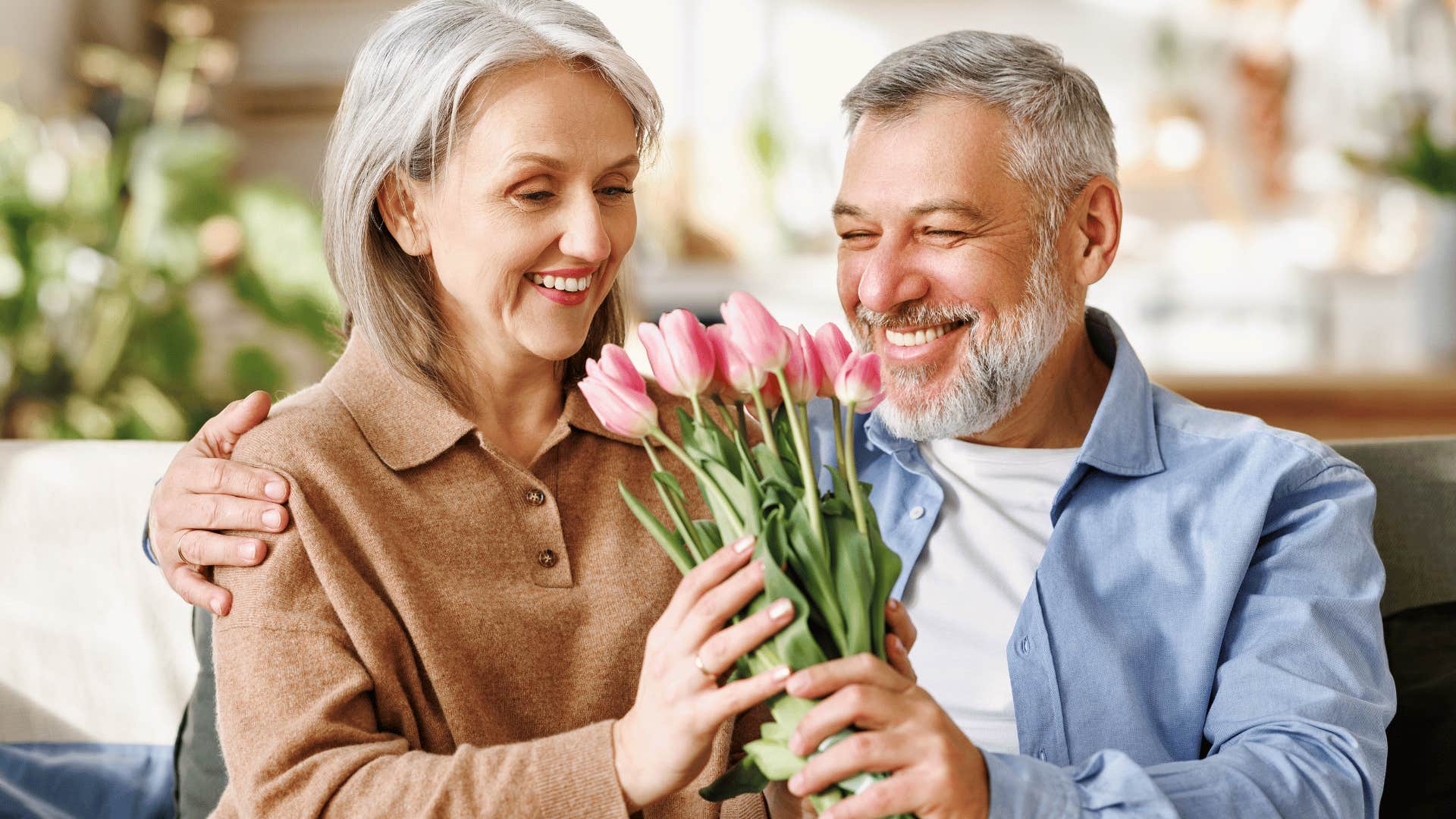 woman receiving flowers from man