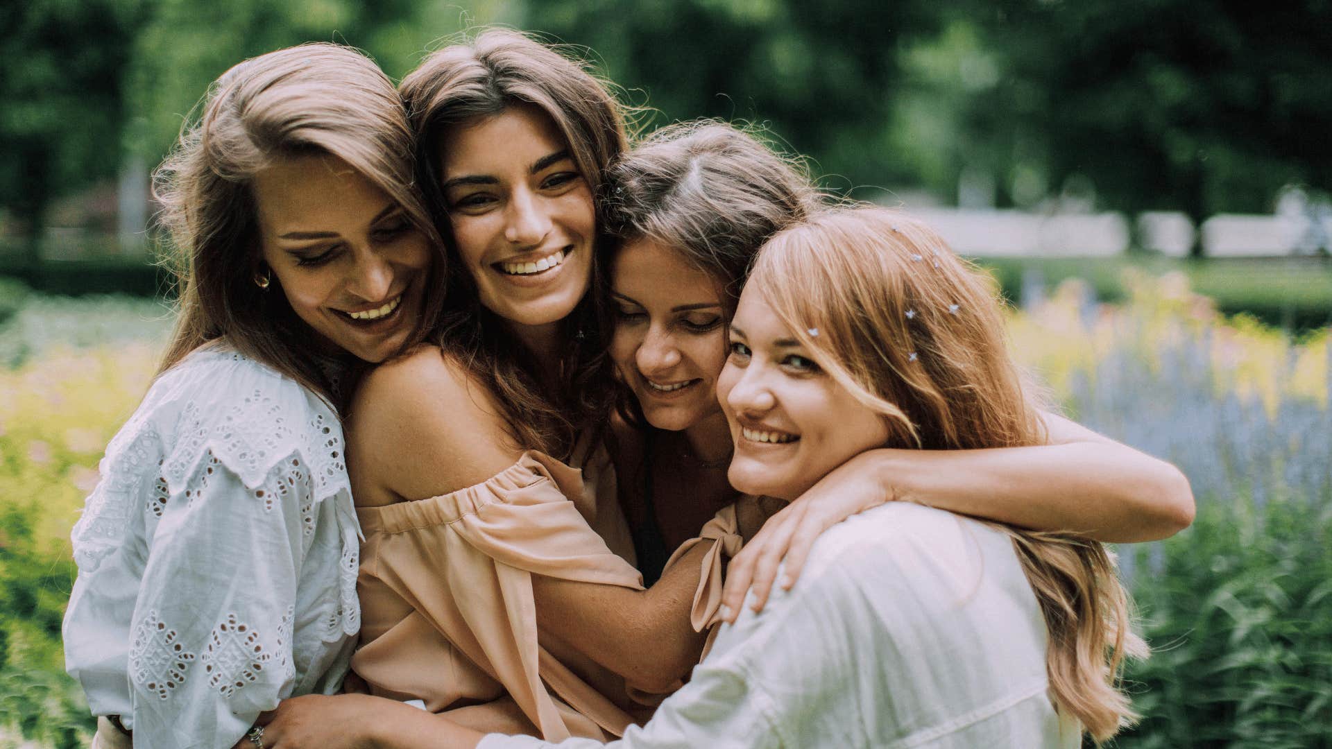 group of woman hugging outside