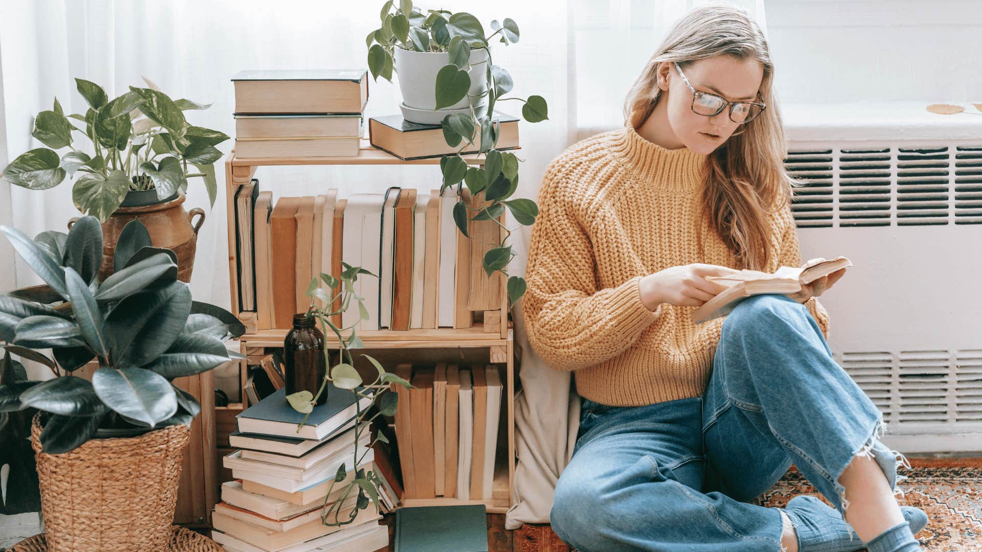 woman reading while sitting on floor