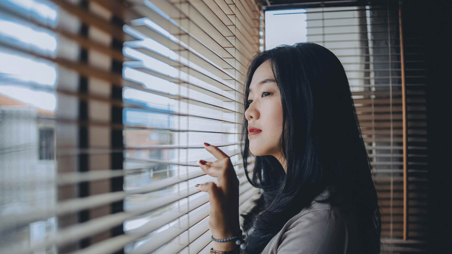 intelligent woman looking out window