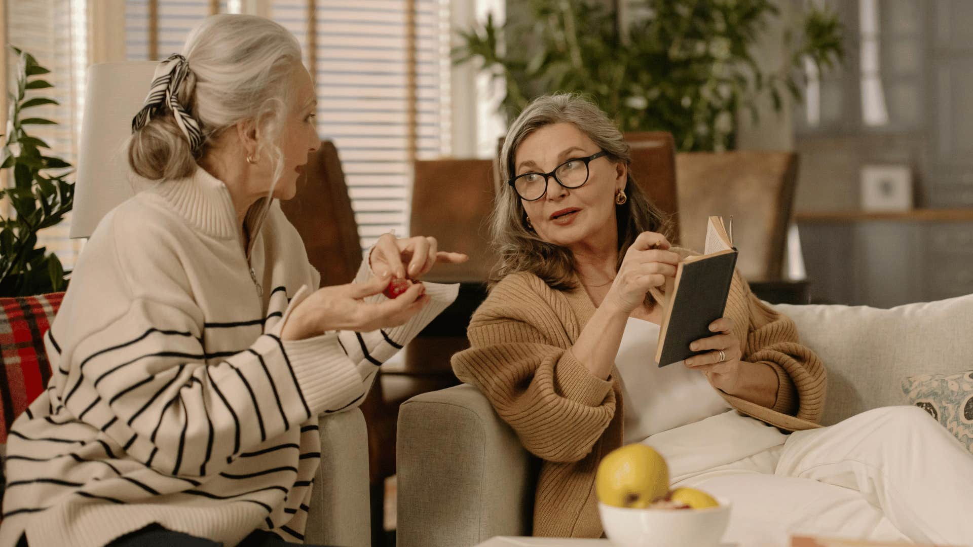 two intelligent woman conversing on couch