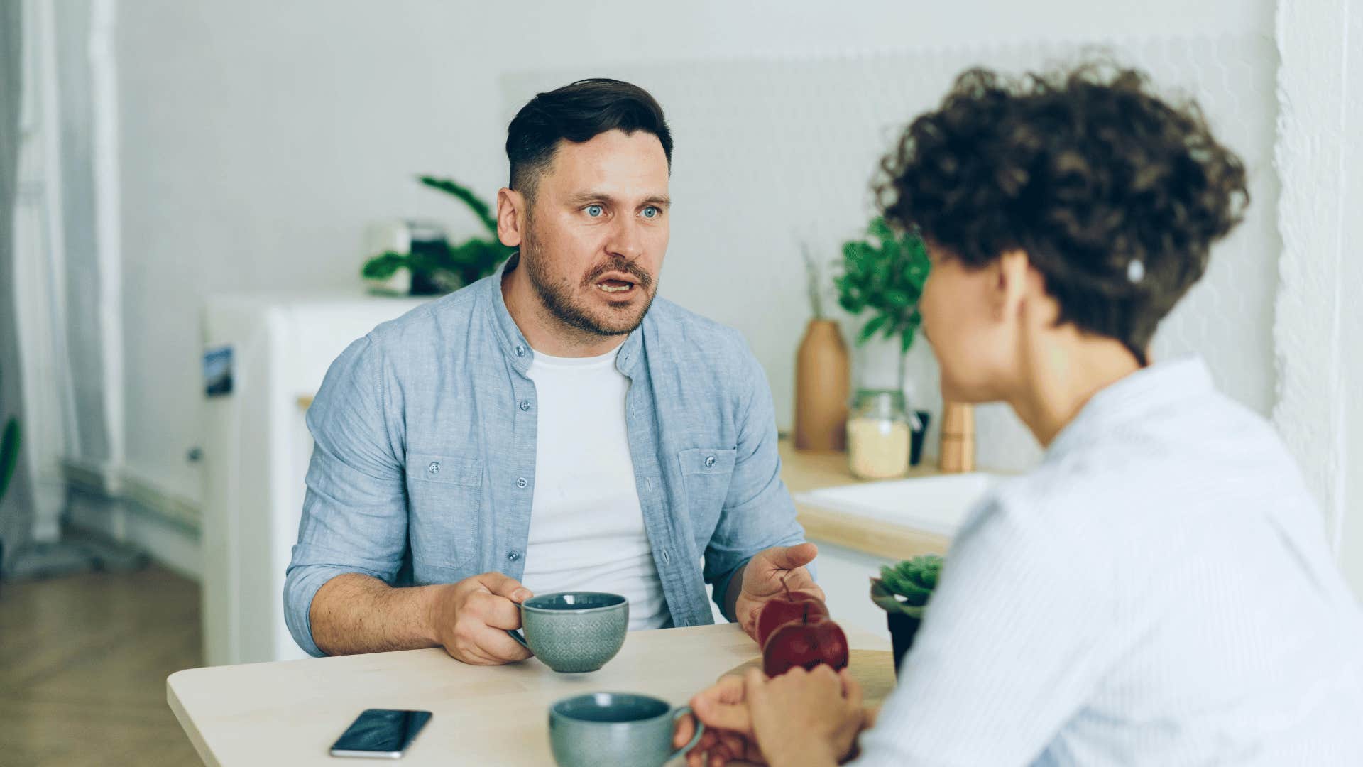 couple having argument at breakfast table