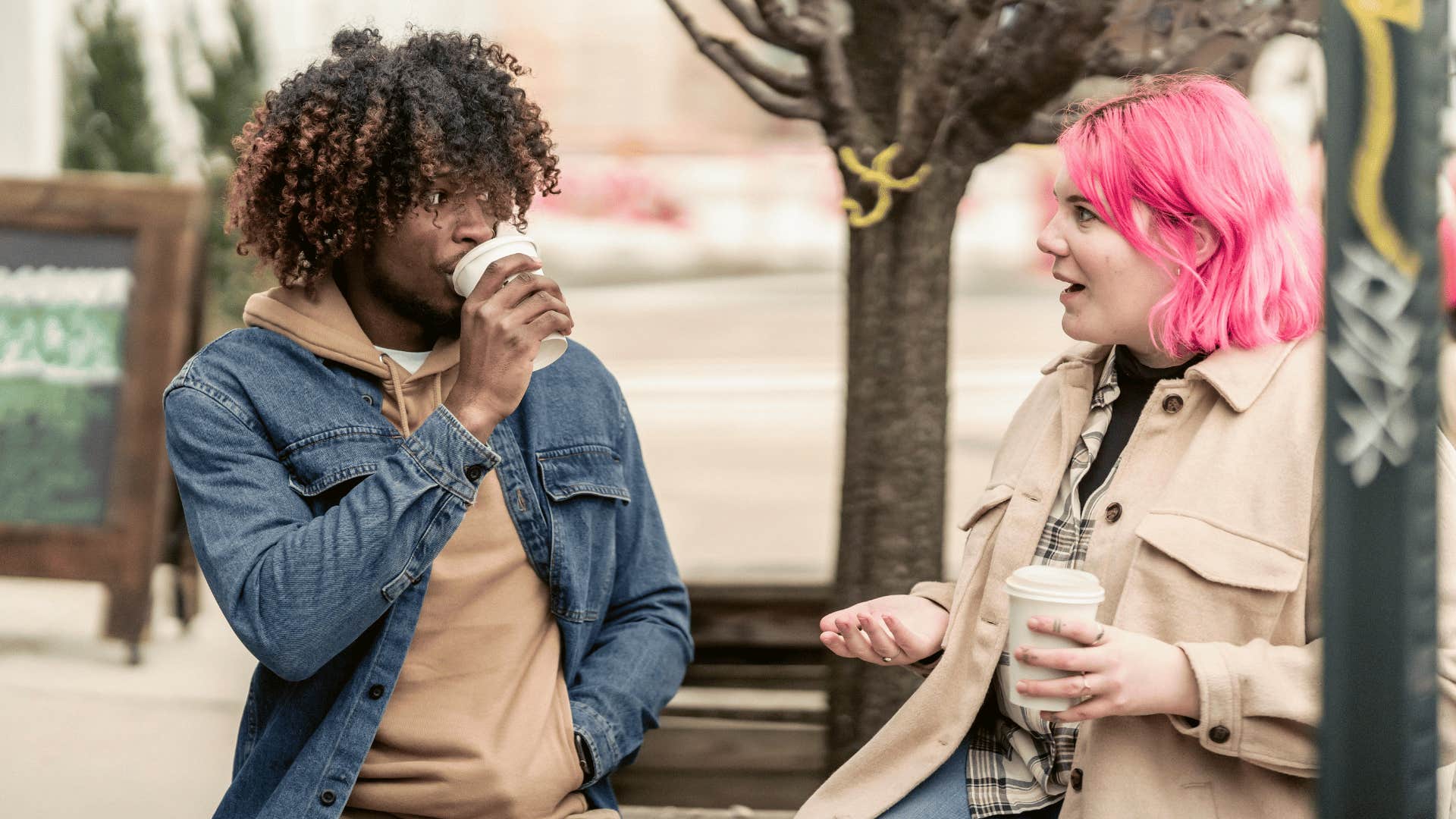man and woman drinking coffee talking