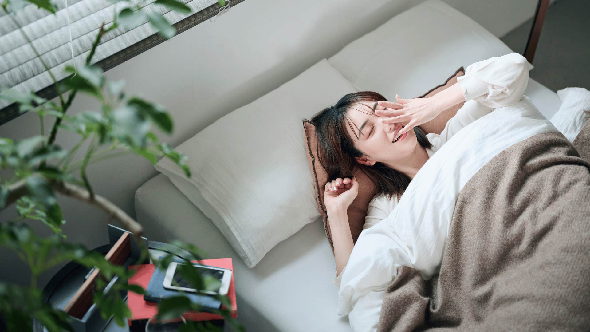 woman filled with tiredness waking up