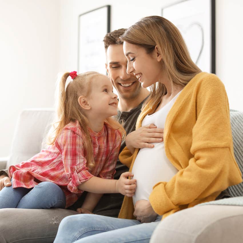 Husband, pregnant wife, and daughter