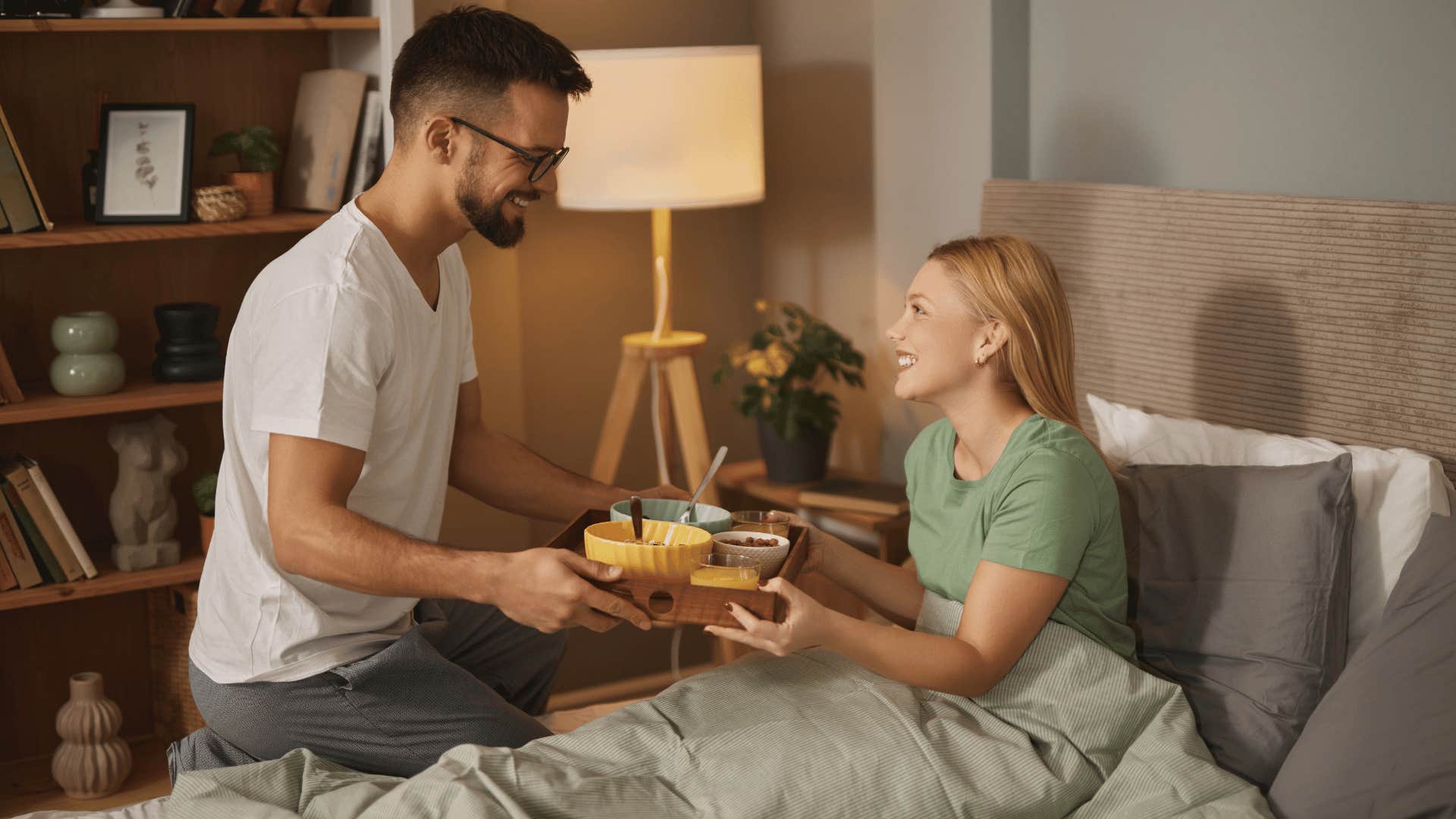 man bringing wife breakfast in bed